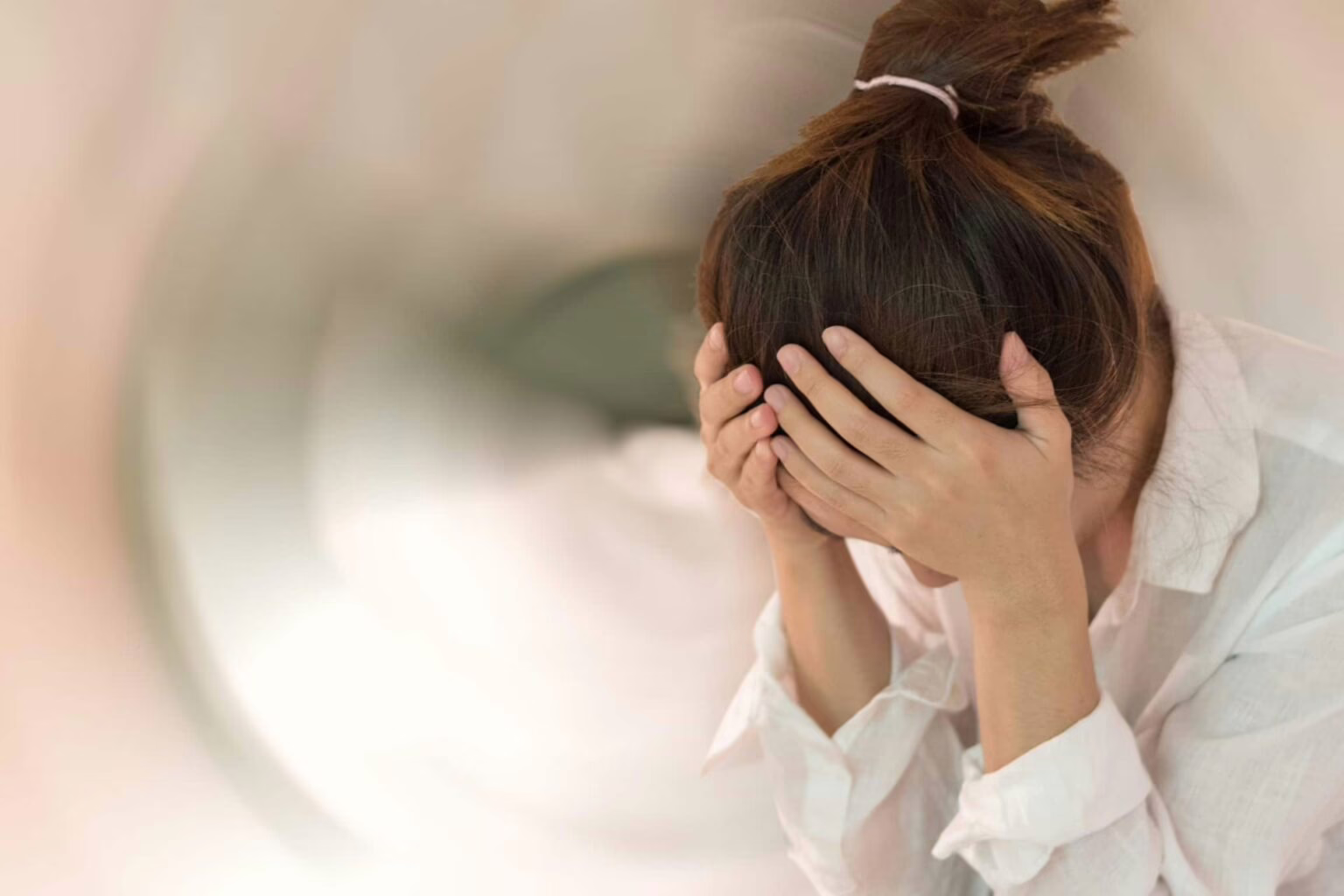 suffering from Benign paroxysmal positional vertigo woman holding head and suffering from bppv