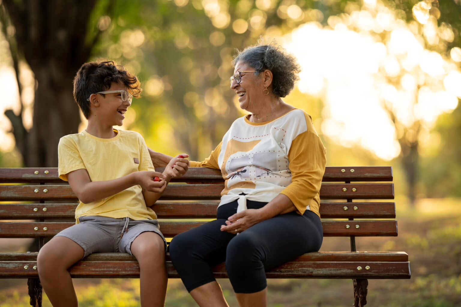 Grandmother and grandchild in sitting on a park bench